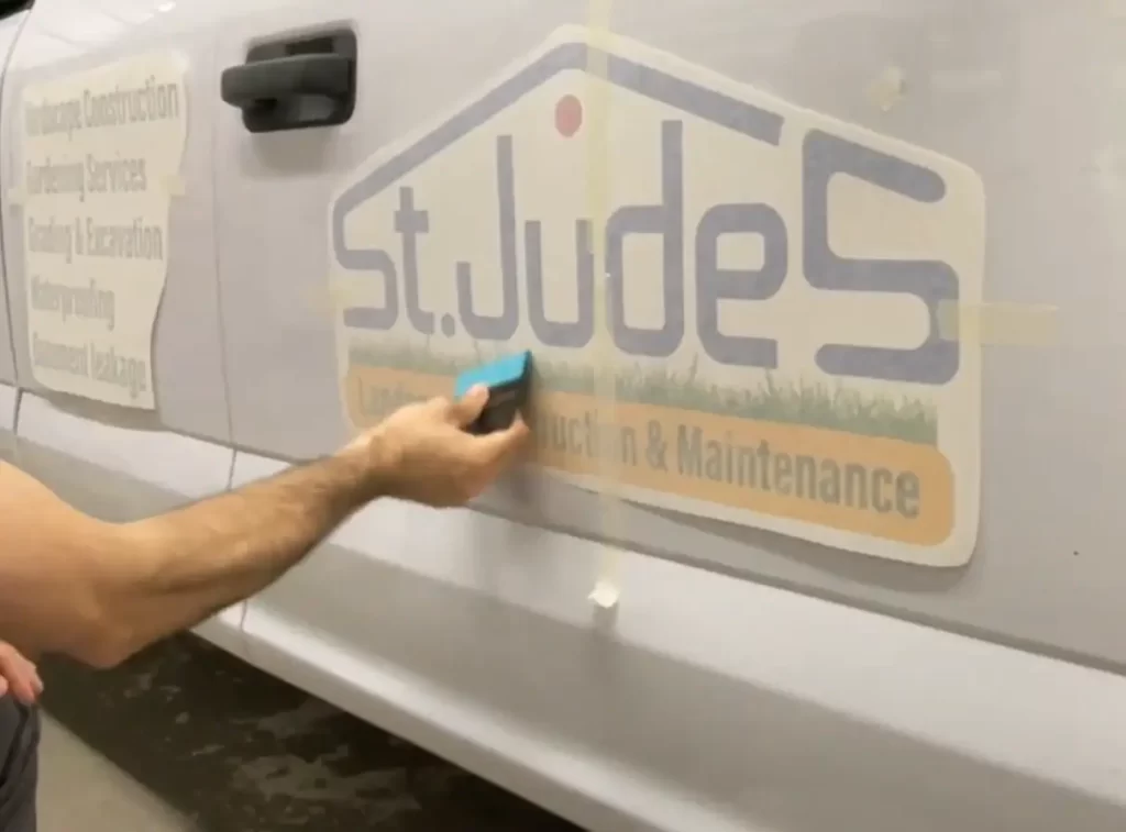 Apply the decal to the surface using the squeegee