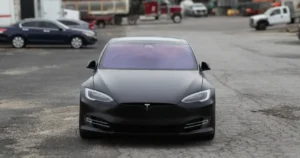 A front view of a Tesla Model S with a custom matte finish vinyl wrap