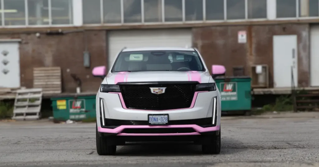 Front view of a Cadillac Escalade displaying a pink partial wrap