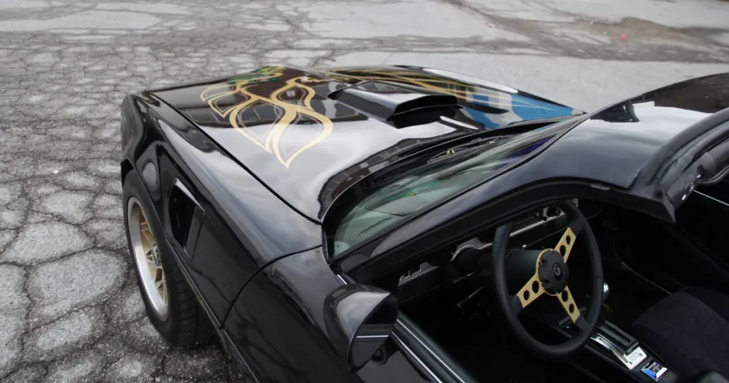 Angled view of a Pontiac Trans Am featuring custom decal wraps.