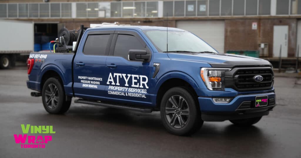 Blue pickup truck with white ATYER Property Services Logo to showcase DIY vs. Professional truck decal